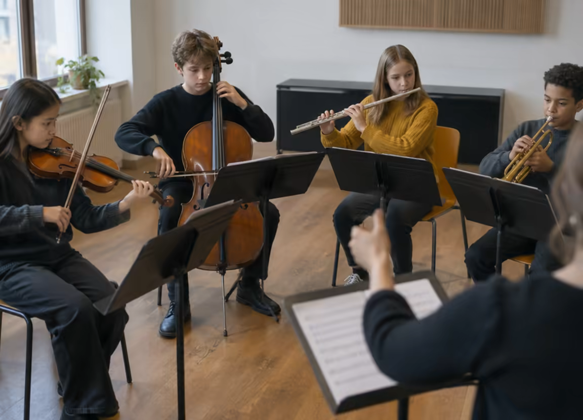 A youth ensemble rehearsing with violin, cello, flute and trumpet